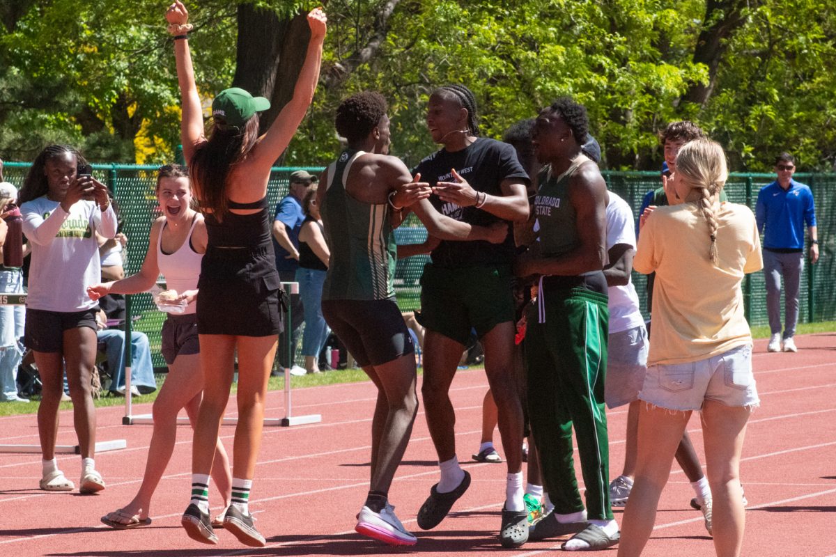 Colorado State University athlete Ndayiragije Shukurani celebrates with his teammates after a program record-setting triple jump mark of 16.13 meters May 2. 