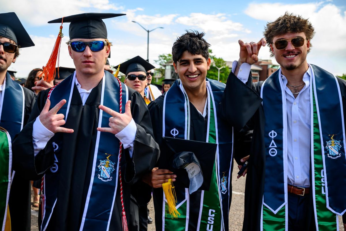 Colorado State University graduates pose for a photo before the Universitywide Commencement ceremony in Canvas Stadium May 16.