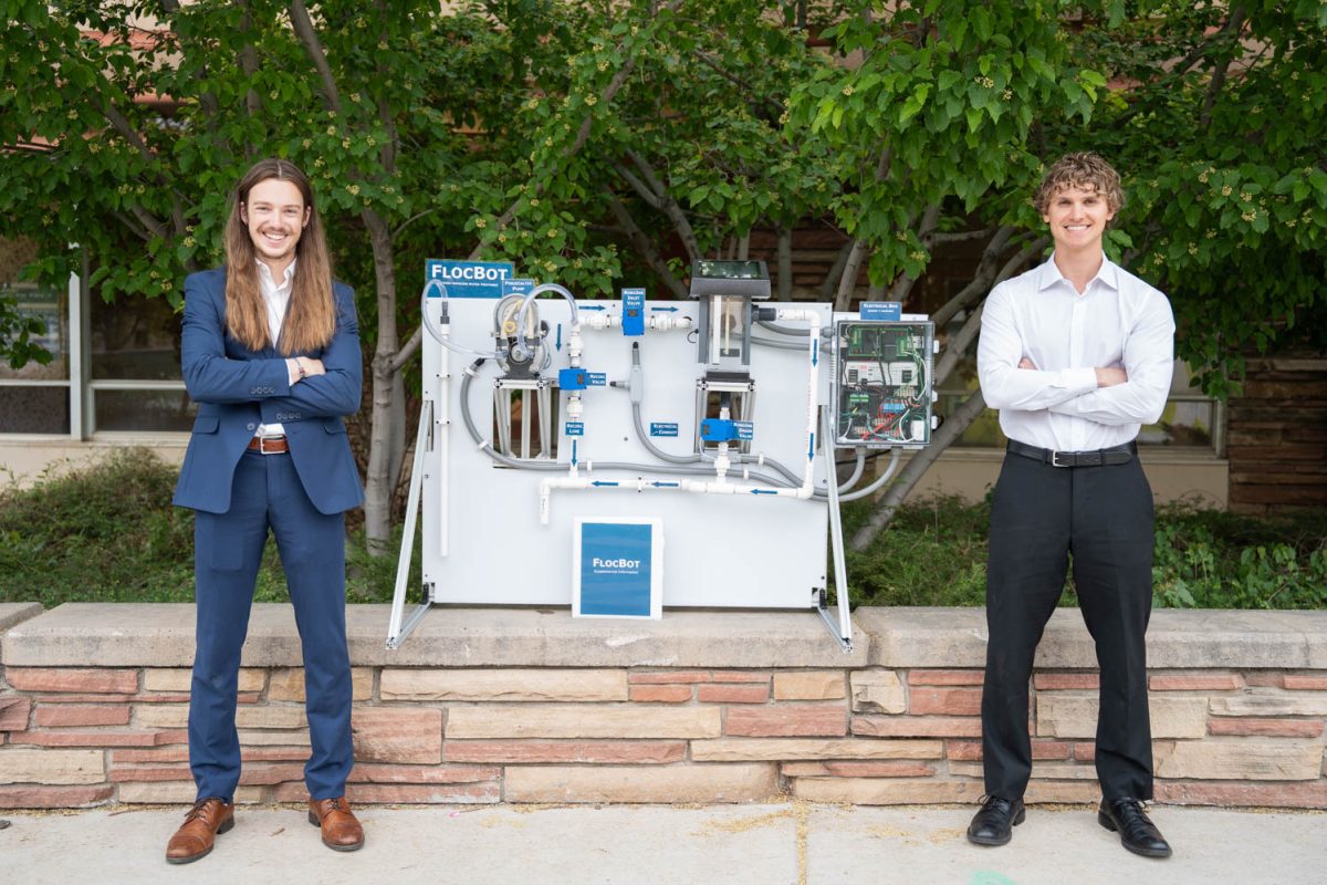 The founders of FlocBot, Josh Kates (Left) and Hugh McCurren (Right), stand by the water treatment system outside the Colorado State Engineering Building, April 29.