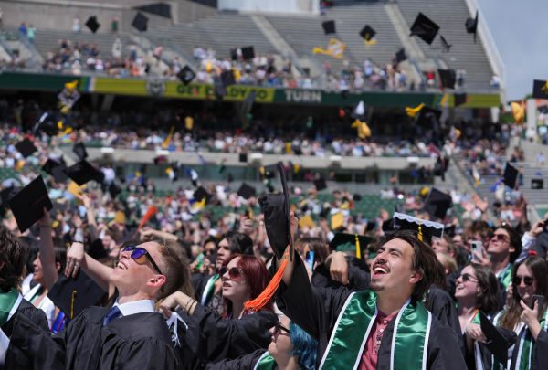 Colorado State University graduates toss their caps in the air in Canvas Stadium for the Universitywide Commencement ceremony May 16.