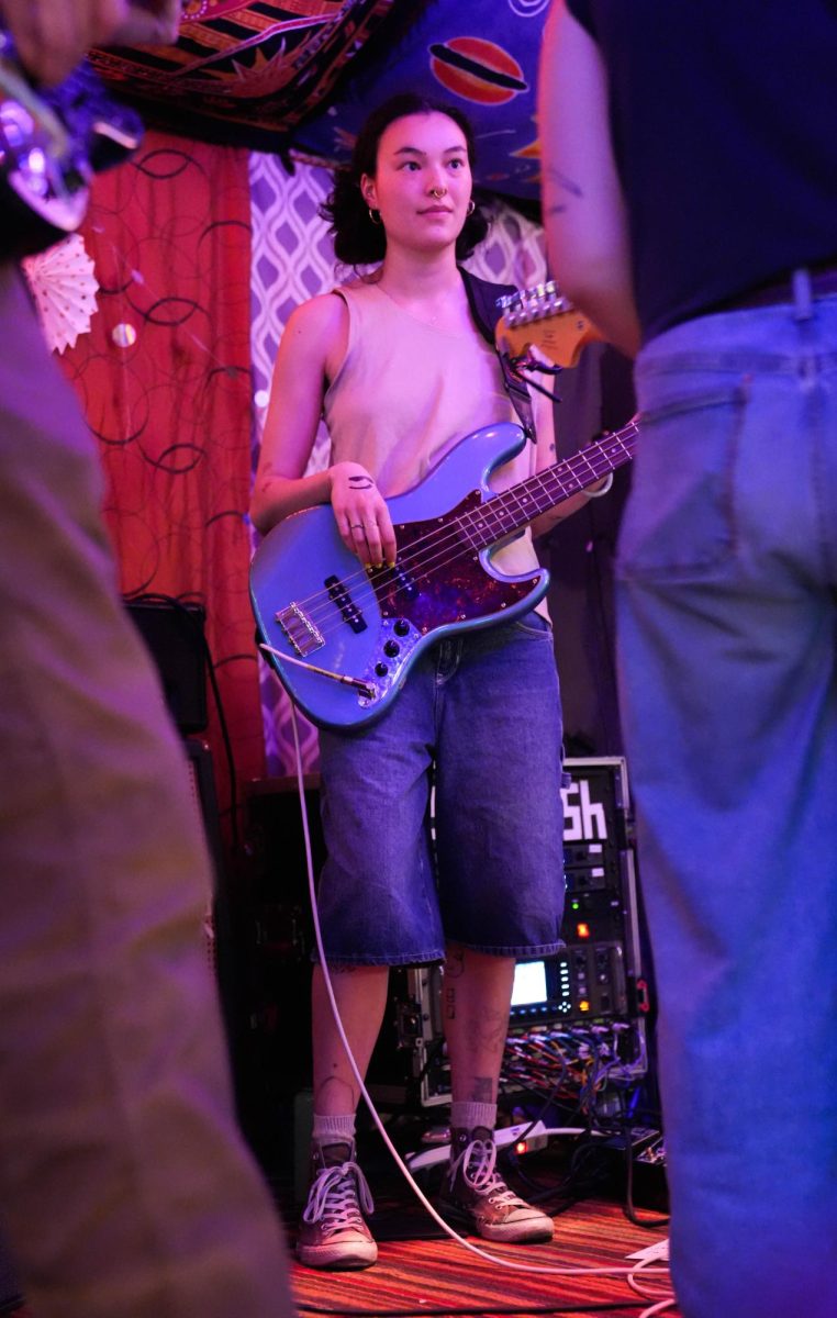 Julia Fegelman holds her instrument after finishing a song July 5. Fegelman was part of the band Bobby.