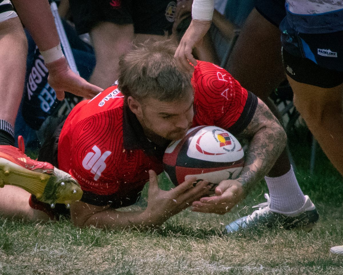 A player for the Gentlemen of Aspen Rugby Club holds the ball after a tackle in a match against Vail Rugby Club, in Aspen, July 5. The gents won with a final score of 37-36. 