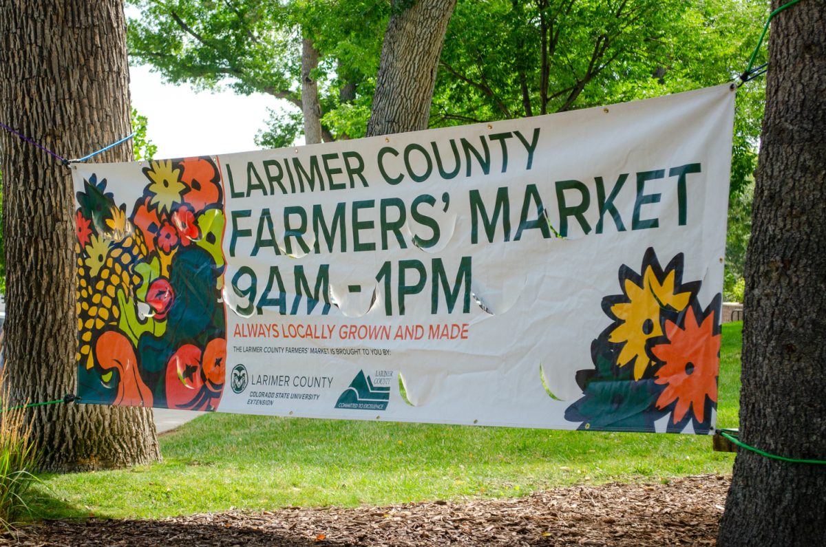 A banner on display at the Larimer County Farmers’ Market Aug. 15