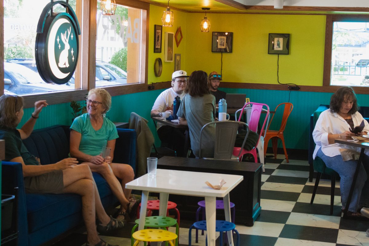Customers chat while enjoying their food and drinks at Trickster Bakery & Cafe Aug. 20. The bakery opened for business on Aug. 10 and is co-owned by Jenn Lewis and Shannon Morr. “Both of us are just really kind of proud of the vibe we’re cultivating here,” Morr said. “It’s nice to see all these people coming in and (being) excited about our, like, pride flags on our doors, and all our colorful chairs and couches and stuff and our big community table.”