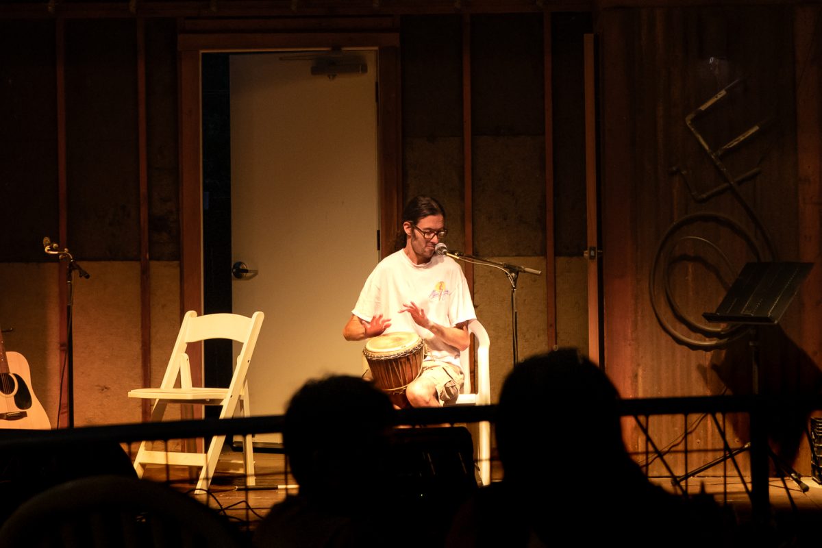 Audience watches Dylan Leen play the drums during open mic night at Avogadro's Number Sept. 1.