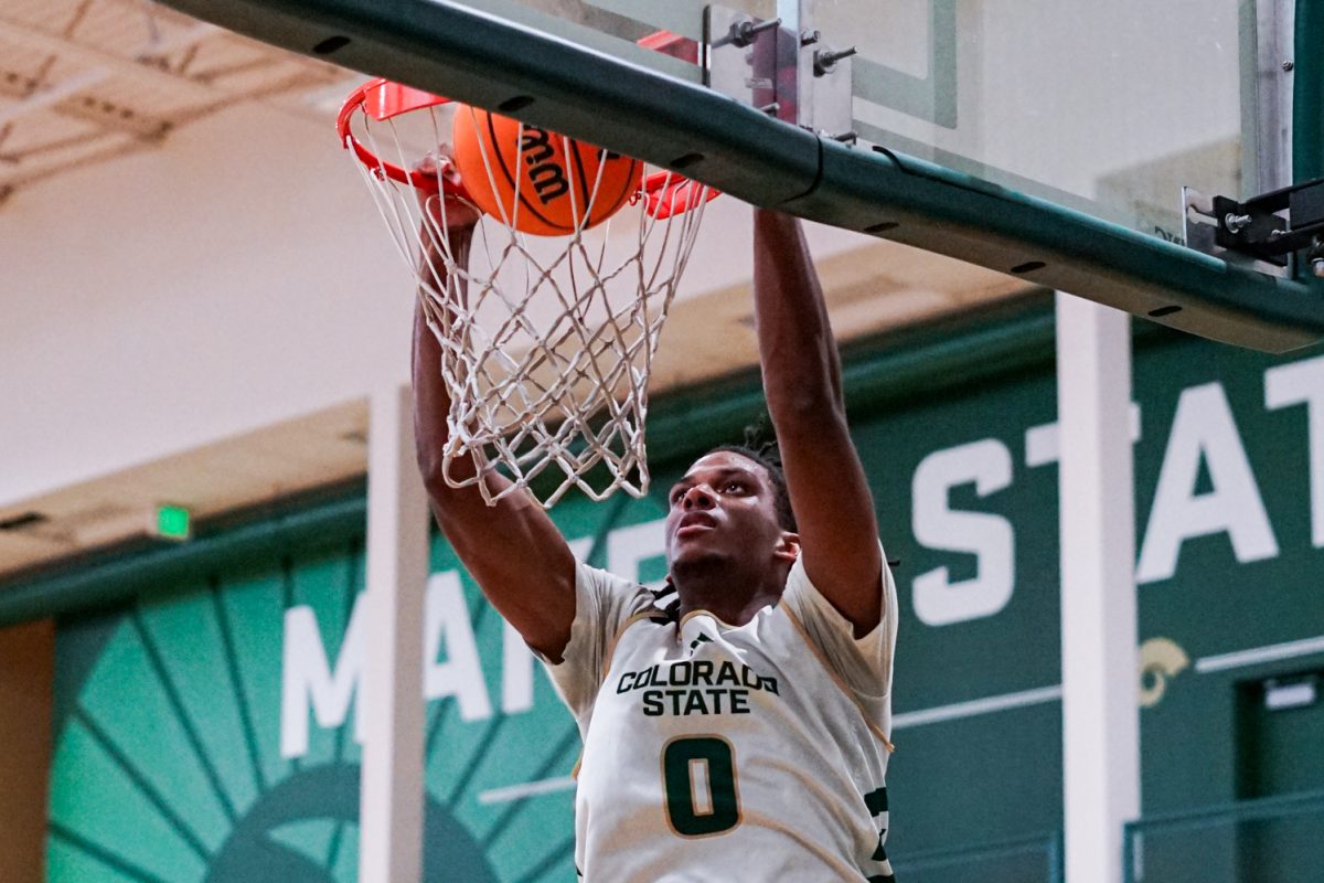 Carey Booth (0), a forward on the Colorado State University men's basketball team, dunks the ball during a practice in CSU's indoor practice facility Sept. 24.