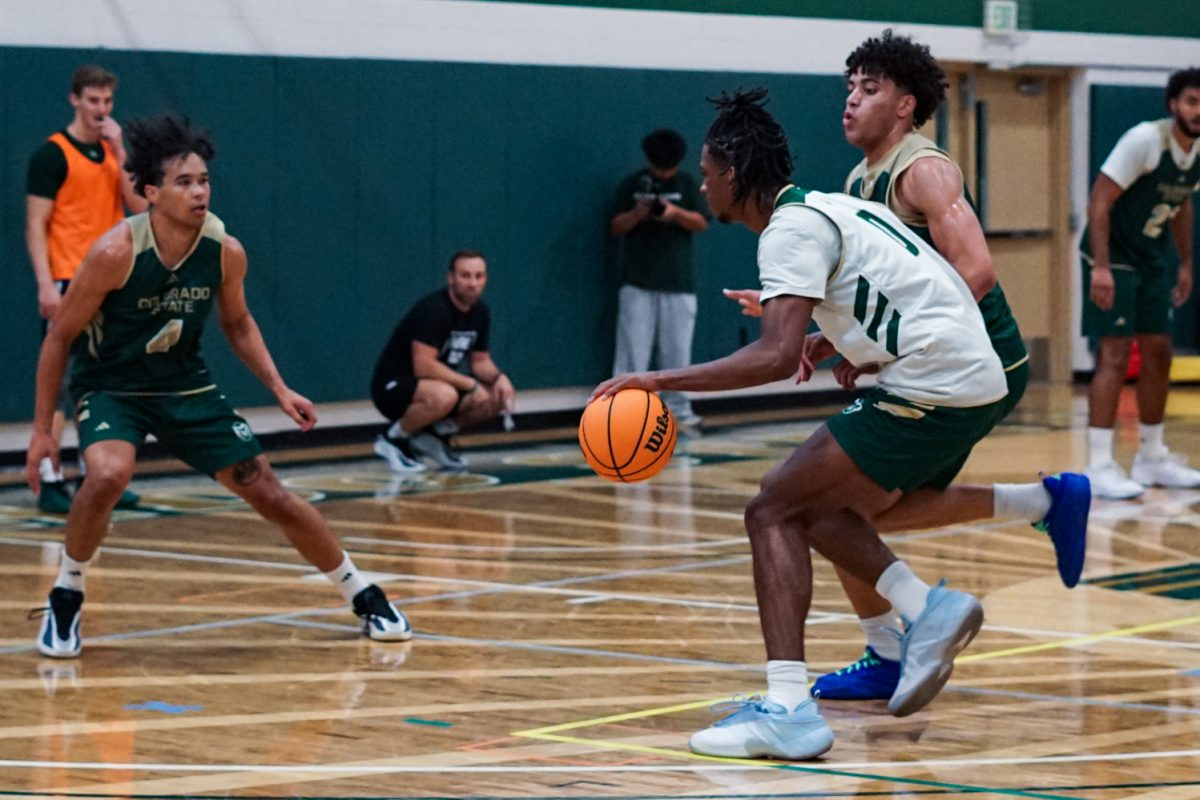 Carey Booth (0), a forward on the Colorado State University men's basketball team, dribbles the ball towards Jase Butler (4) during an afternoon practice in CSU's indoor practice facility Sept. 24.
