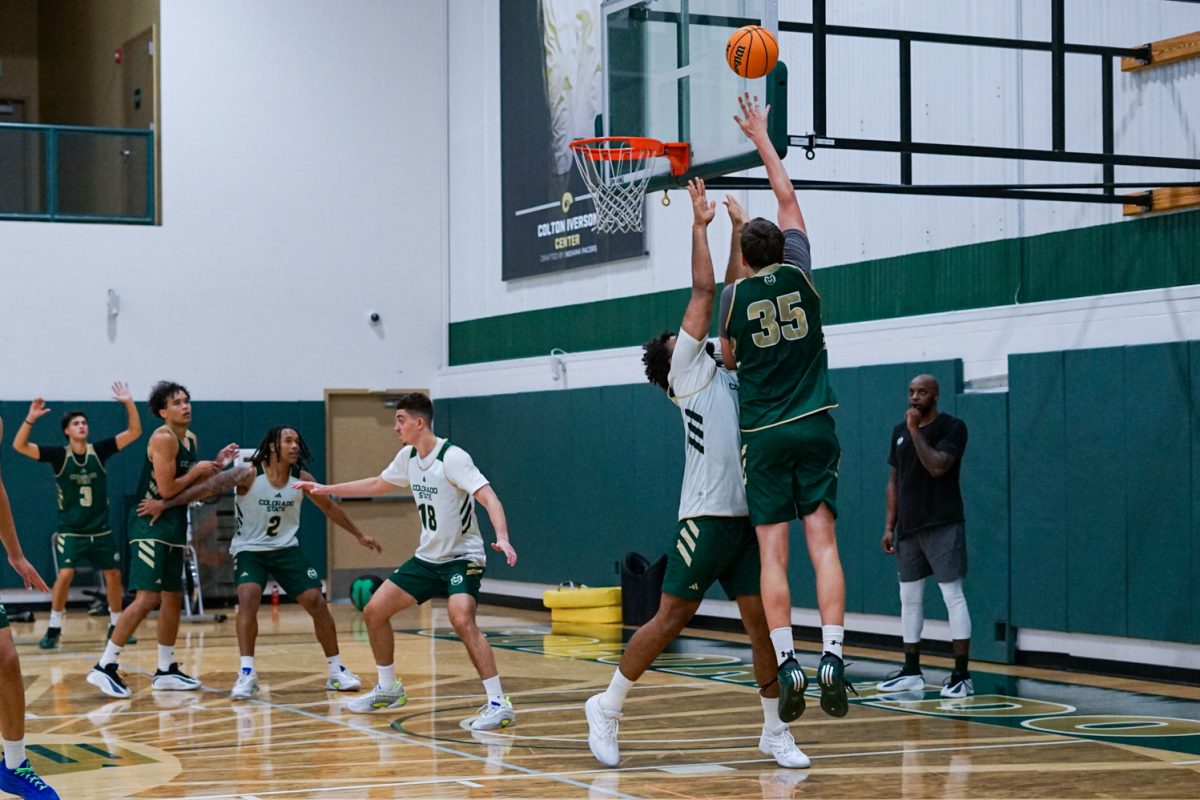 Kyle Jorgensen (35) jumps to shoot the ball as his teammates defend during a practice session at Colorado State University's indoor practice facility Sept. 24.