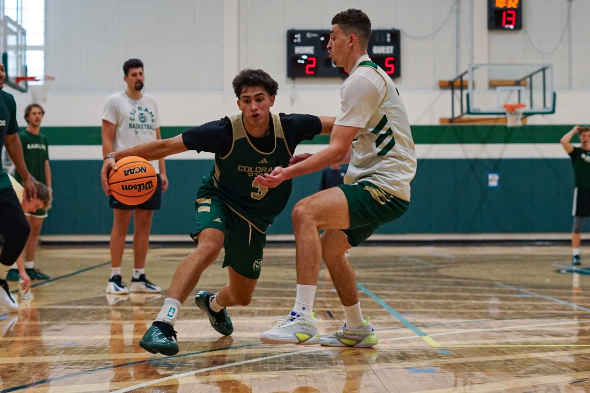 Justin Menard (3), a guard on the Colorado State University men's basketball team, dribbles the ball while blocking a defending teammate during a practice at Colorado State University's indoor practice facility Sept. 24.