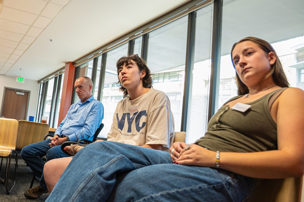 John Henderson, Chelsea Isackson and Naomi Kramer follow along the discussion in the Food for Thought event at the Foundry Sept. 3. 