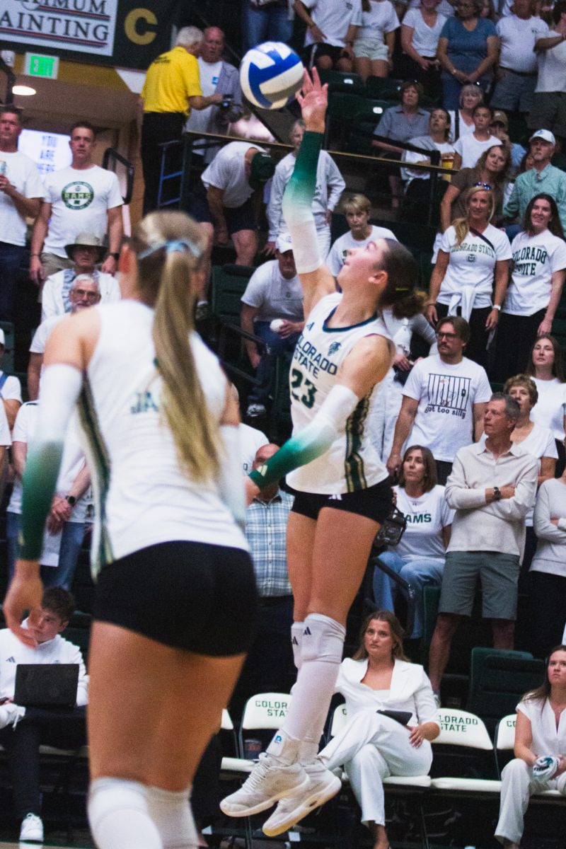 Erin Debiec (23), a setter on the Colorado State University volleyball team, reaches for the ball during CSU's white-out game against the University of Colorado, Boulder in Moby Arena Sept. 18. Debiec put up 33 of CSU's 35 assists, pushing the Rams to win the second match of the double-header in three straight sets, and win the golden spike.
