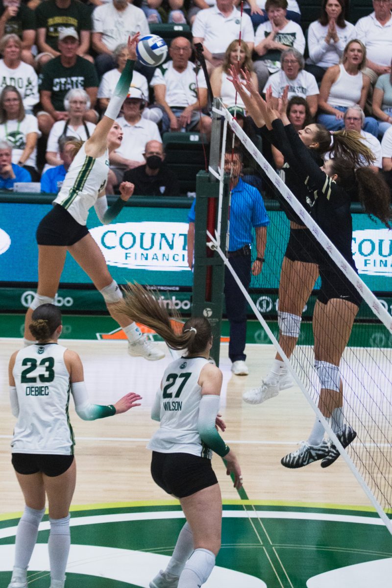 A Colorado State University volleyball player swings her arm to spike the ball at the University of Colorado, Boulder team during CSU's white-out game in Moby Arena Sept. 18. The Rams won night two of the double-header in three straight sets, winning the golden spike.