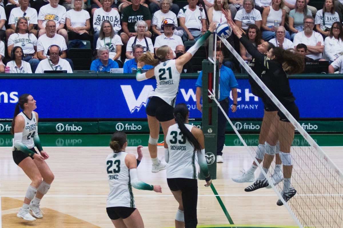 Ella Stowell (21) taps the ball over the net during Colorado State University's volleyball game against the University of Colorado, Boulder in Moby Arena Sept. 18. 8,083 fans packed the stadium for CSU's white-out game to watch the Rams beat the Buffaloes in three straight sets, assisted by Stowell's 10 attacks.