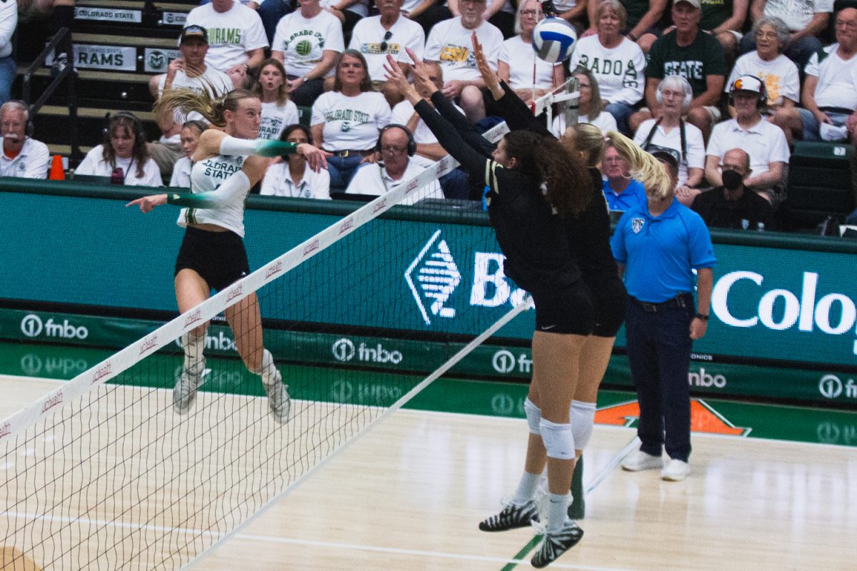 Halle Jameson (4), an outside hitter on the Colorado State University volleyball team, follows through after hitting the ball at the opposing team during CSU's white-out game against the University of Colorado, Boulder in Moby Arena Sept. 18. The Rams showed out for a home crowd of 8,083 fans, winning the golden spike after sweeping the Buffaloes 3-0.