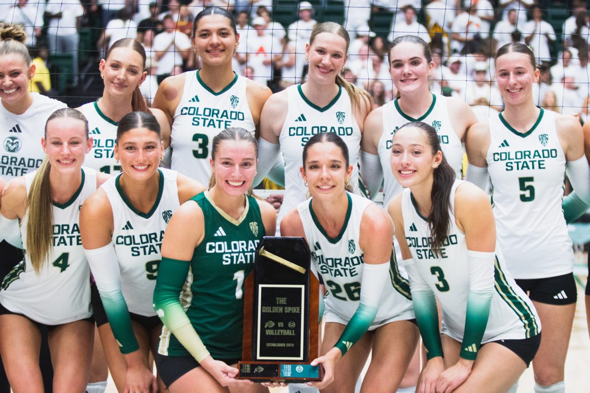 Colorado State University volleyball players pose for a photo with the golden spike trophy after CSU's comeback victory against the University of Colorado, Boulder Sept. 18. 8,083 fans packed Moby arena for the Rams' white-out game, cheering CSU on to win three straight sets against CU.