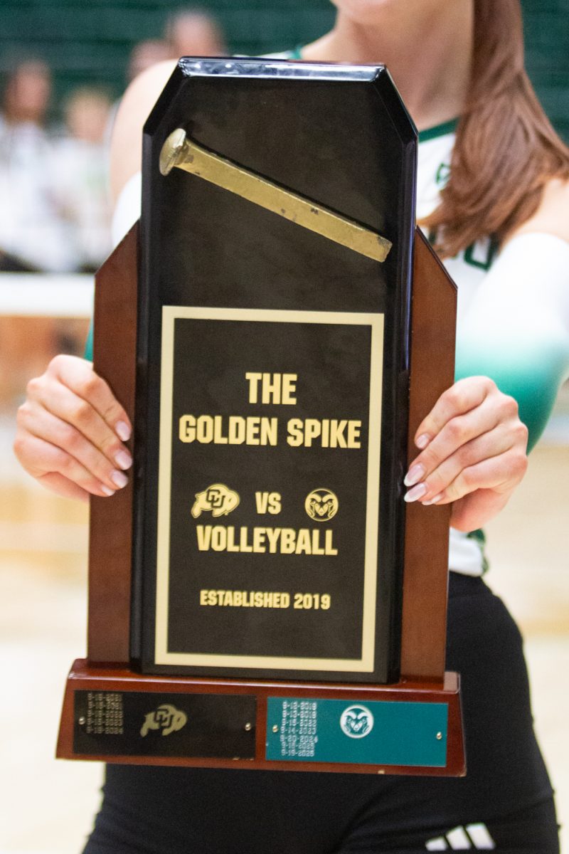 A Colorado State University volleyball player holds the golden spike trophy in front of the camera Sept. 18. After 90 attacks and 39 kills, CSU beat the University of Colorado, Boulder in three straight sets on the second night of their double header, to win the golden spike.