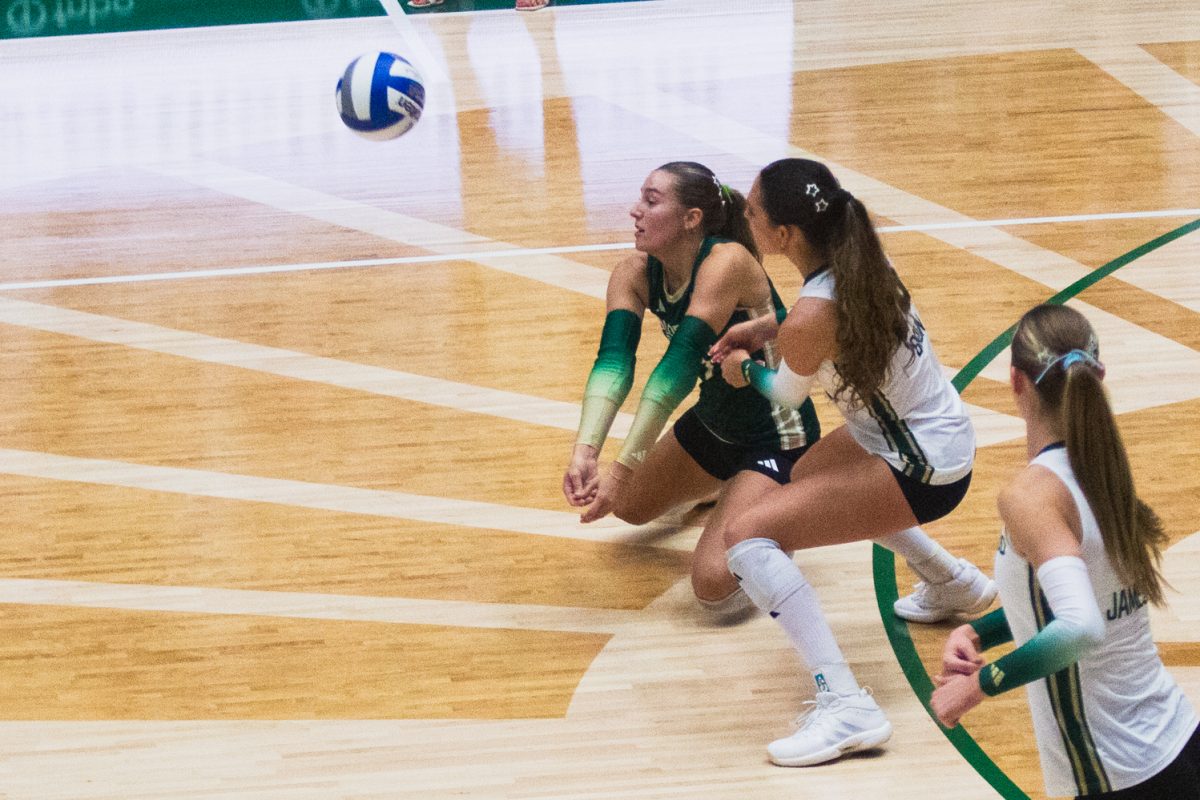 Karsyn Fetzer (1) and Maria Brun (26) line up to return a serve from the University of Colorado, Boulder volleyball team during their white-out game Sept. 17. After winning the second game of the rivalry double-header, the Rams won the golden spike.