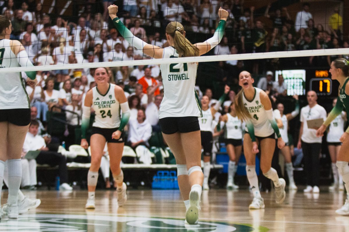 Ella Stowell (21), an outside hitter on the Colorado State University volleyball team, turns to her teammates to celebrate during the second set of CSU's white-out game against the University of Colorado Boulder Sept. 18. 