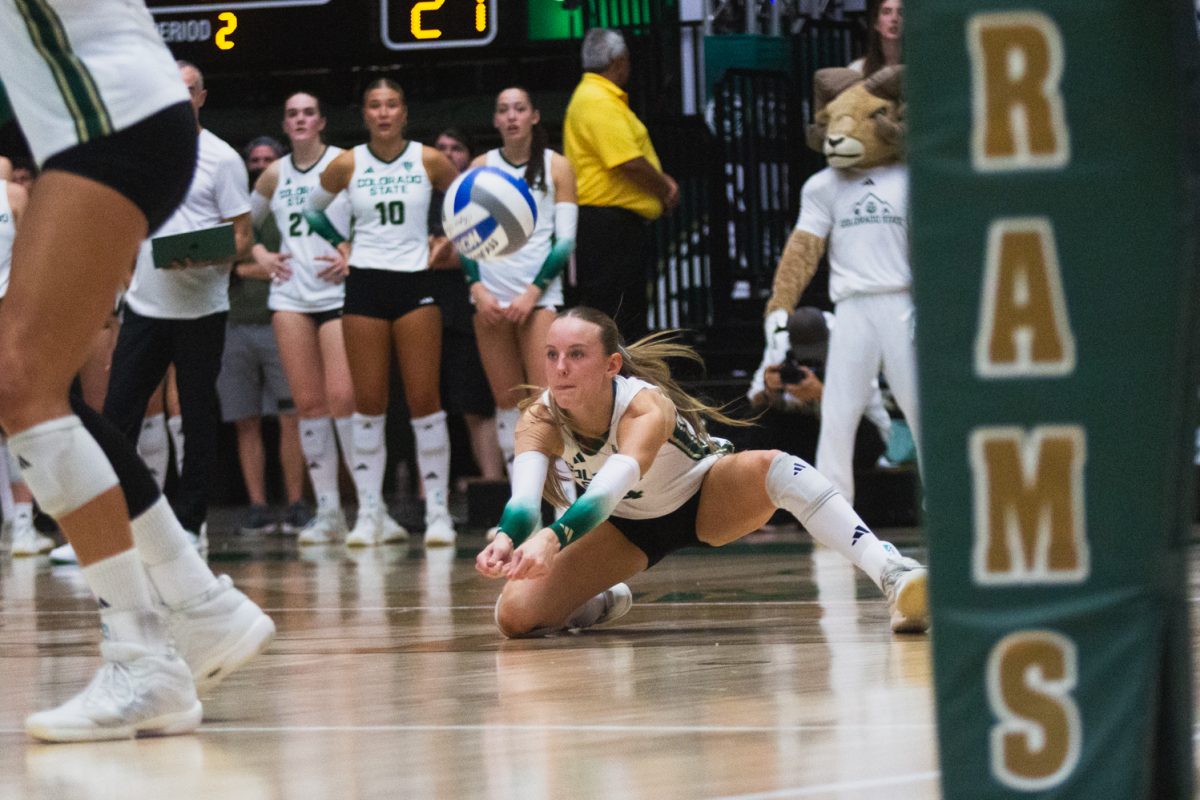 Halle Jameson (4), a Colorado State University volleyball player, positions herself to bump the ball during CSU's white-out game against the University of Colorado, Boulder in Moby Arena Sept. 18. During this second game of a double-header against CU, Jameson's 29 attacks helped the Rams to come back from a night one loss and sweep the Buffs 3-0.