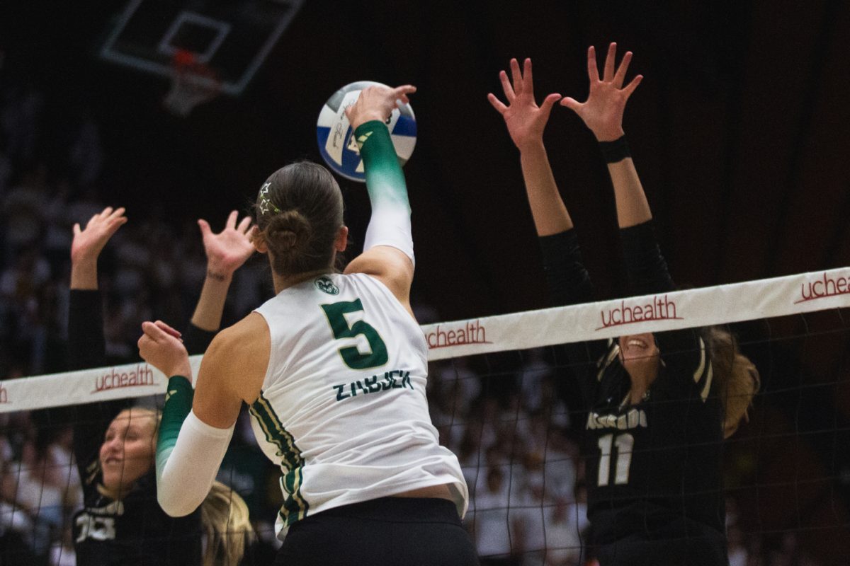 Sofia Zabjek (5), a Colorado State University volleyball player, spikes the ball past the arms of her opponents to score a point for the Rams during their white-out game against the University of Colorado, Boulder Sept. 18. Moby Arena cheered the Rams on to a dominant victory, where they won against the Buffs in three straight sets, assisted by Zabjek, who led CSU with 9 kills.