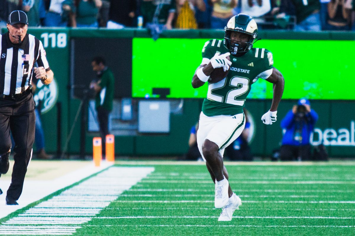 Colorado State University running back Cedric Ross (22) runs the ball down the field during CSU's game against Brigham Young University in Canvas Stadium Sept. 19. 