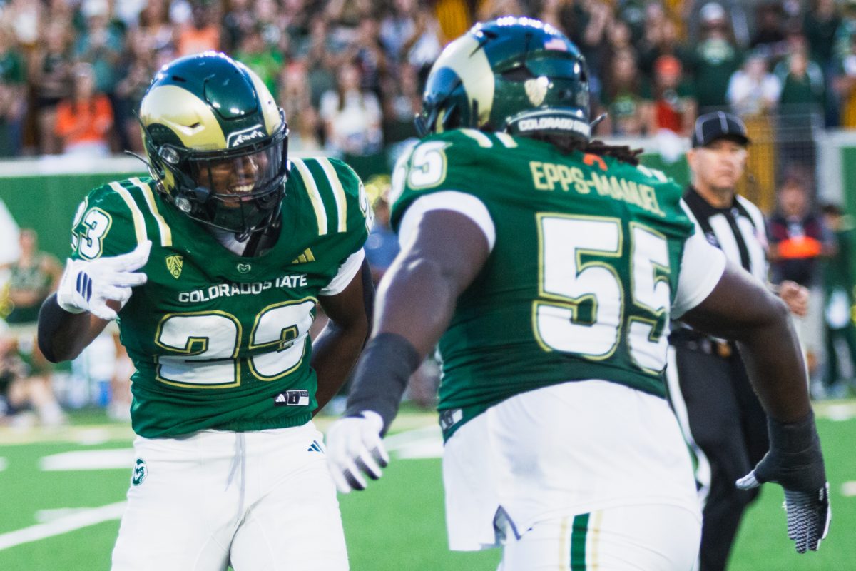 Colorado State University linebacker Jaseim Mitchell (23) celebrates a tackle with his teammate Desman Epps-Manuel (55) during the first half of CSU's game against Brigham Young University Sept. 19. CSU lost the game 41-23.
