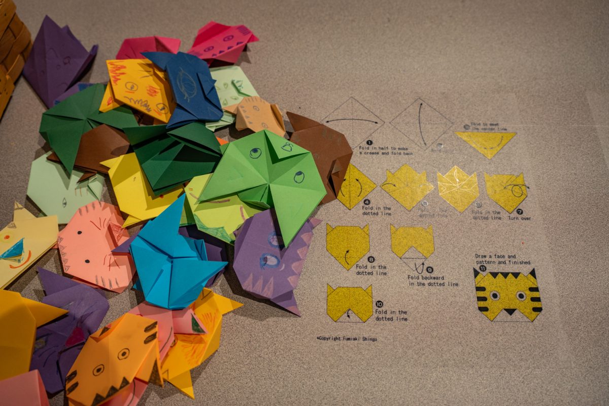 "Zhen’s Journey: Inspire" is displayed in the "Work and Wonder: Behind the Scenes at the Museum" exhibit inside The Global Village Museum of Arts and Cultures Sept. 11. The interactive piece teaches attendees how to create an origami cat.