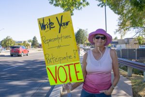 Jean Greuel holds her protest sign at the intersection of College Avenue and Horsetooth Road Sept. 10. 