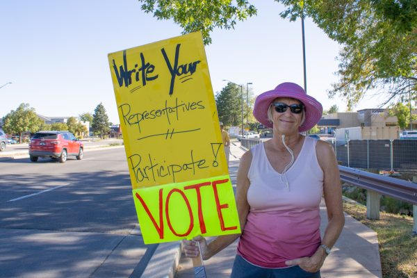 Jean Greuel holds her protest sign at the intersection of College Avenue and Horsetooth Road Sept. 10.