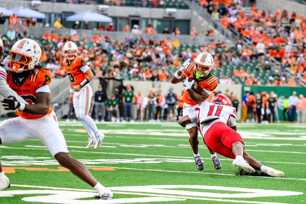 Colorado State University running back Mel Brown (1) pushes through a Southern Utah University defensive player during CSU's Ag Day game Sept. 12. 