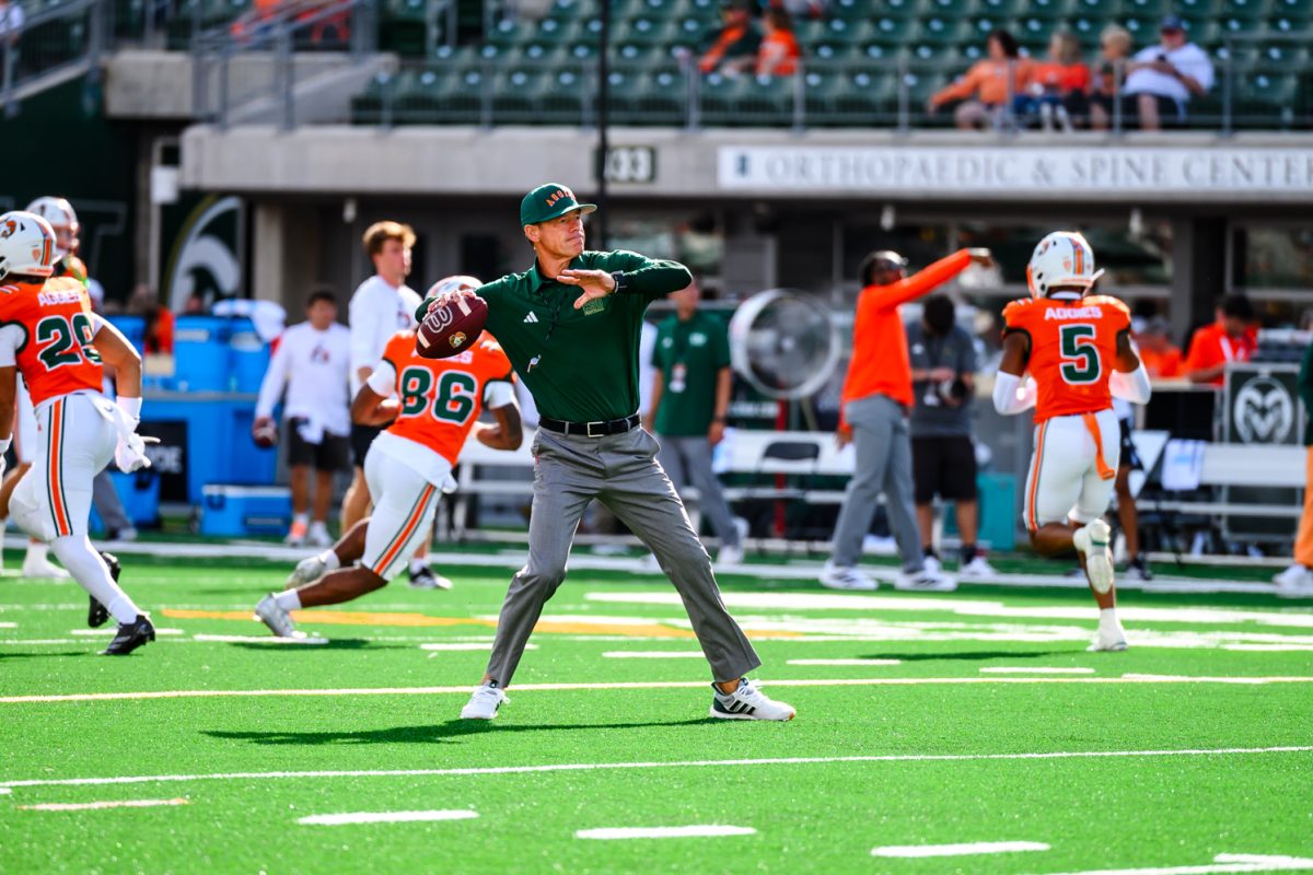 Colorado State University head football coach Jim Mora throws a ball to a CSU wide receiver during warm ups for CSU's Ag Day game against Southern Utah University Sept. 12. The Rams ended Ag Week with a 58-24 win.