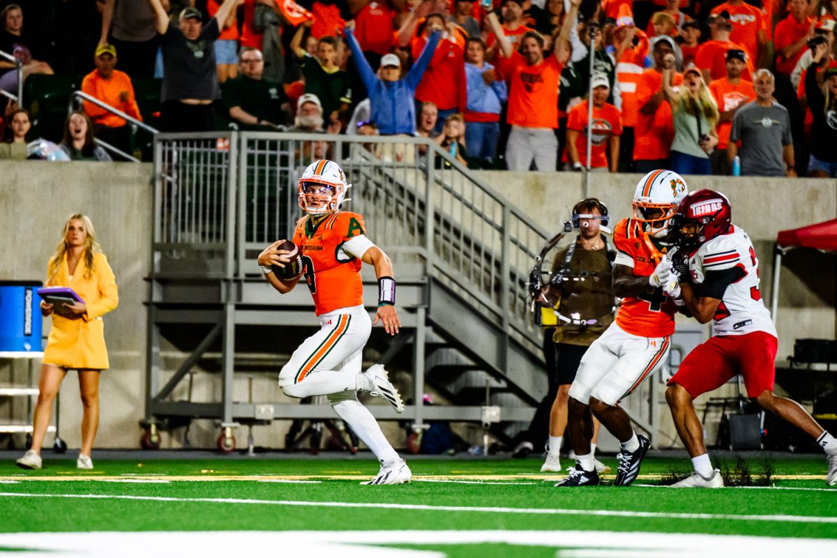 Colorado State University wide receiver Lavon Brown (4) holds a Southern Utah University defensive player away from quarterback Hauss Hejny (8) as Hejny runs for the endzone Sept. 12. Henjy threw 325 yards, connecting 18 of 30 passes.