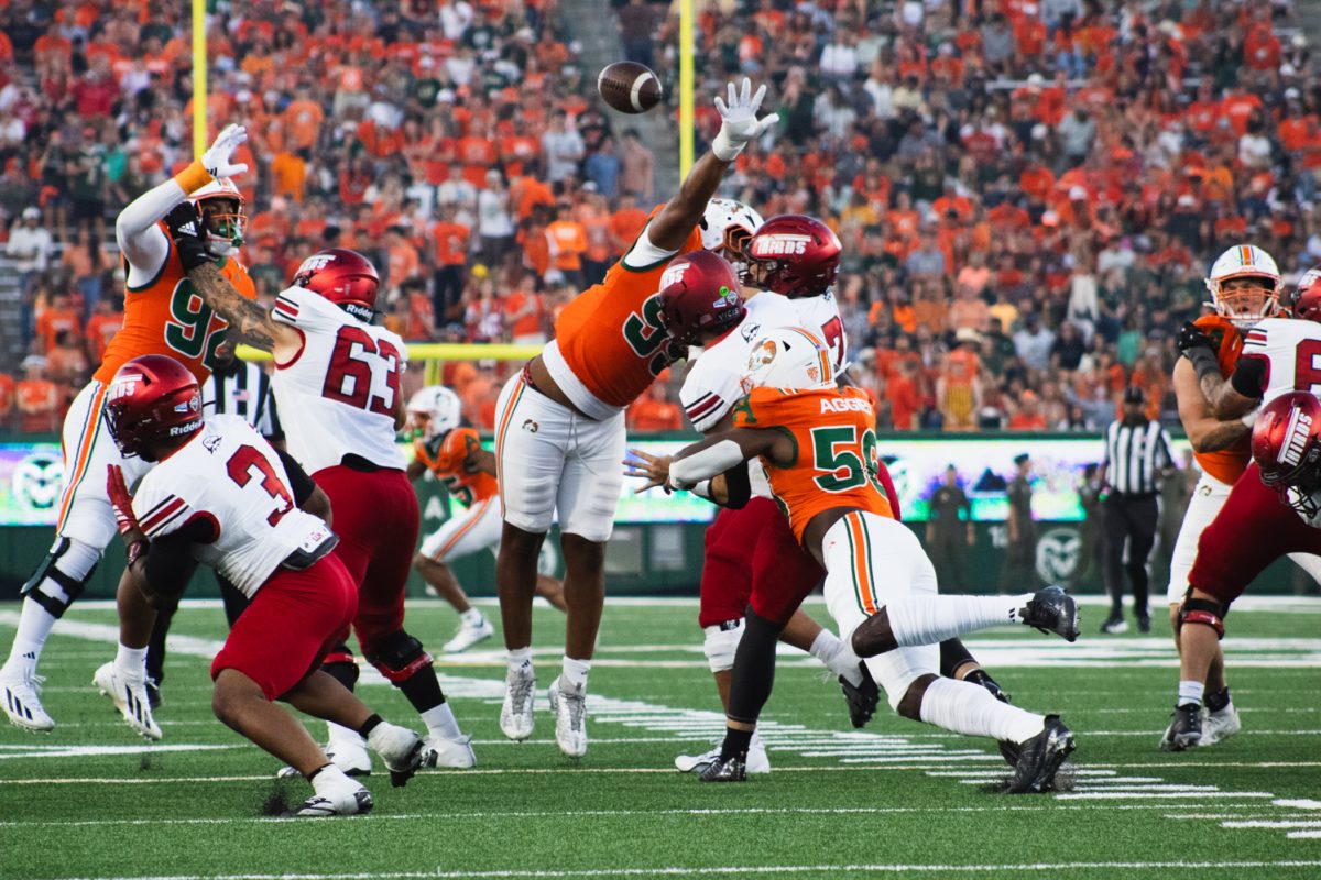 Kenyon Agurs (56) tackles the Southern Utah University quarterback during the Ag Day game Sept. 12. Agurs executed one of CSU's three sacks during their game against SUU, which the Rams won 58-24.