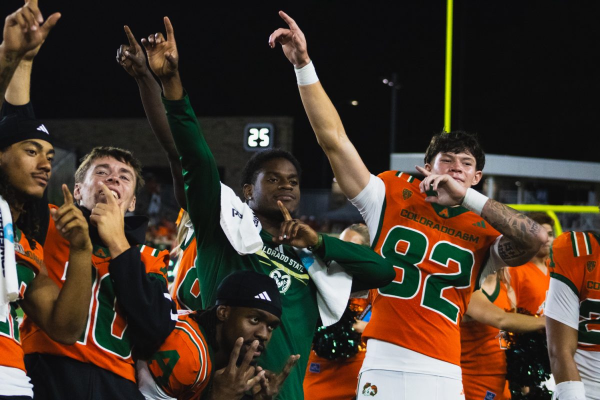 Colorado State University football players pose for a photo while the band plays the alma mater after their win against Southern Utah University Sept. 12. CSU scored seven touchdowns for a winning score of 58-24 against SUU.