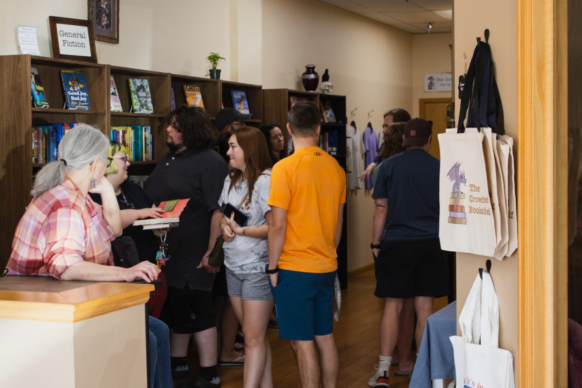 Customers gather and converse inside The Crowded Bookshelf’s new permanent location Sept. 12.