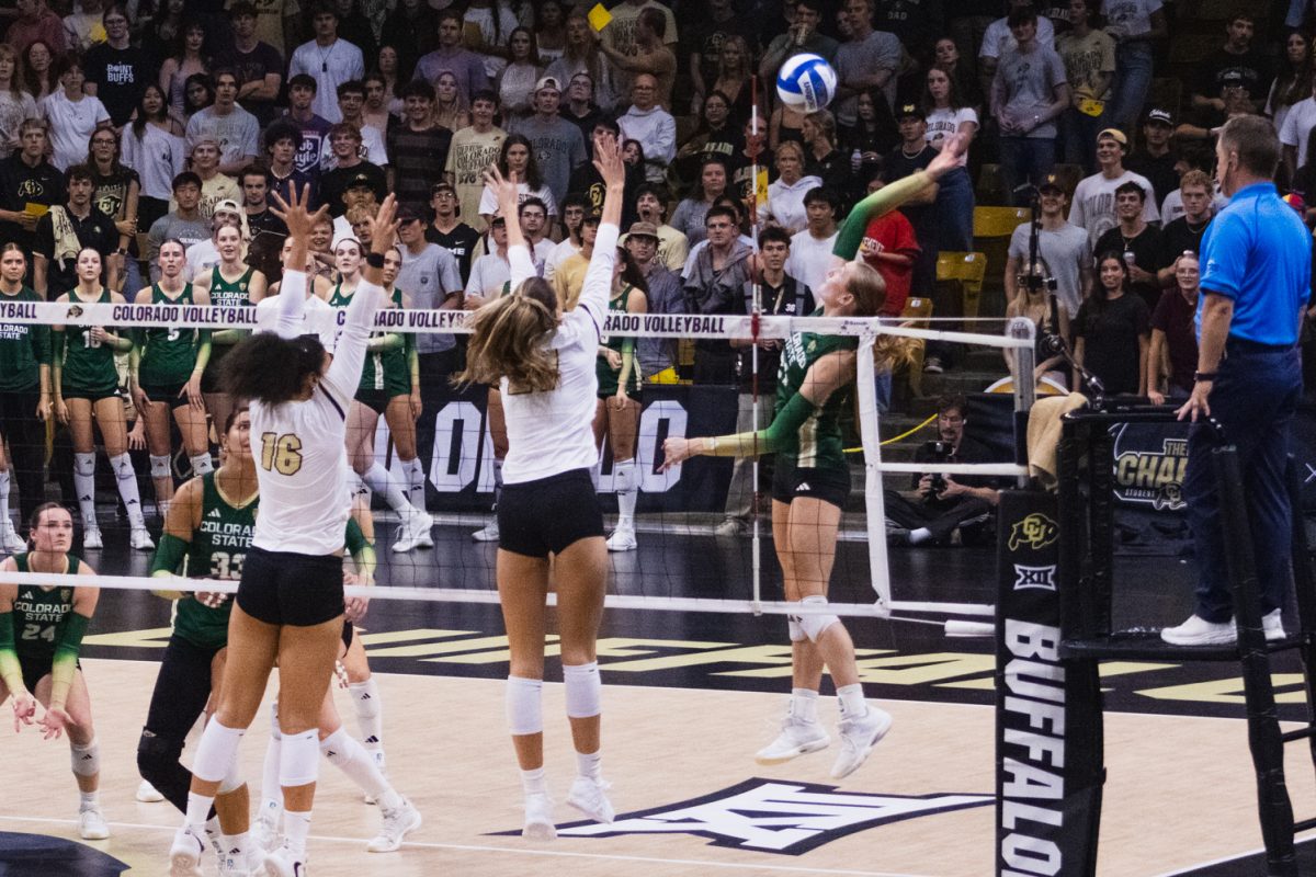 A Colorado State University volleyball player aims to spike the ball over the net during their away match against University of Colorado, Boulder Sept. 17.