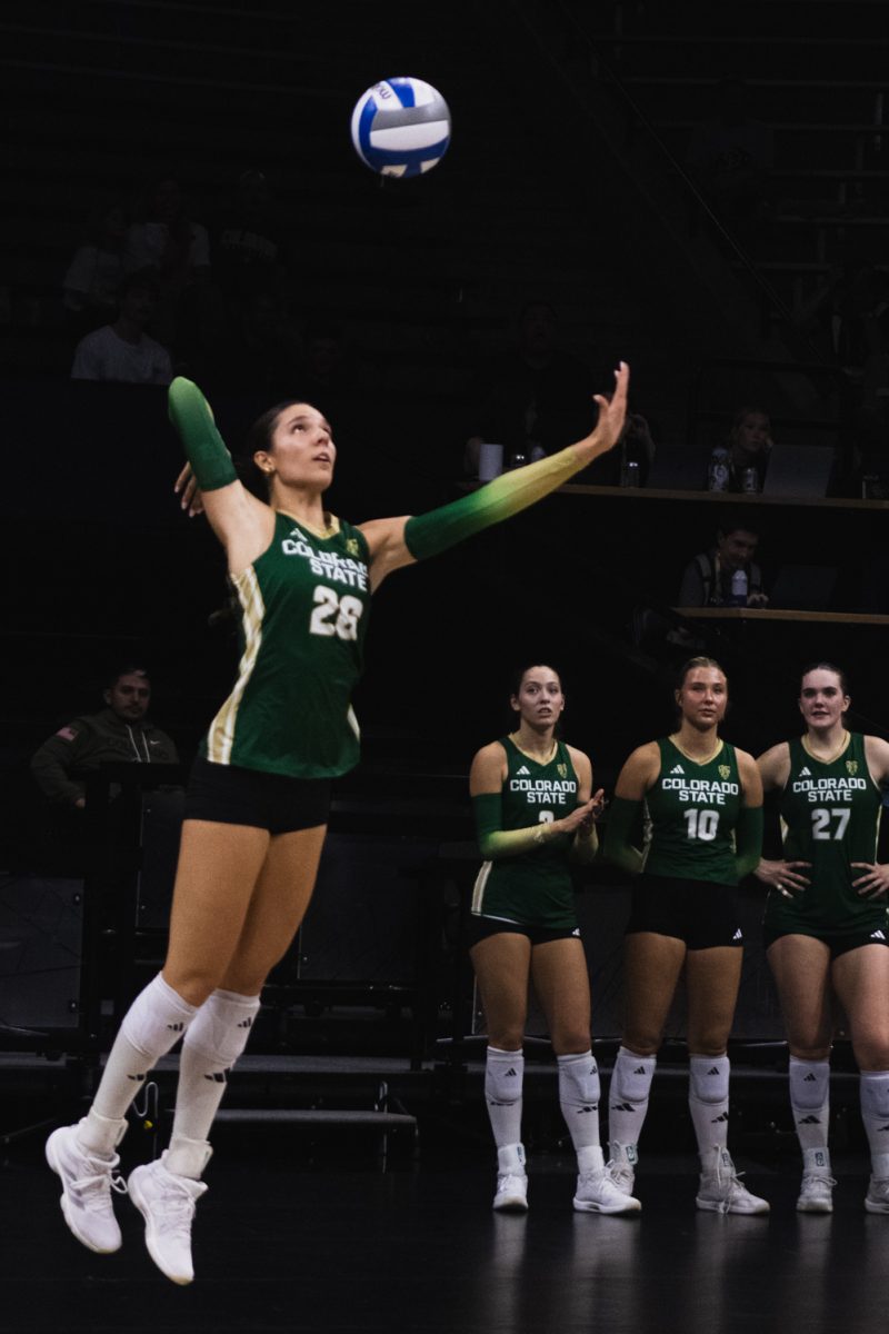 Maria Brun (26), a Junior on the Colorado State University volleyball game, prepares to serve the ball as her teammates cheer her on during CSU's away game against the University of Colorado, Boulder at the CU Boulder Events Center Sept. 17. The match was the first of a double header in the contest for the golden spike, and CSU lost night one 3-1.