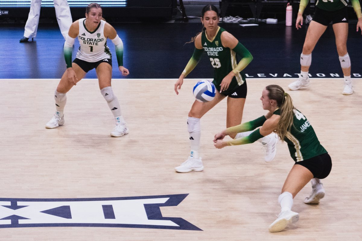 Halle Jameson (4), a Colorado State University volleyball player, prepares to hit the ball served by the University of Colorado, Boulder at the CU Events Center Sept. 17. A 3-1 loss at Boulder spurred the Rams on to sweep the Buffaloes during their second game, in Moby Arena, where a sold-out home crowd would get to see CSU keep the golden spike. 