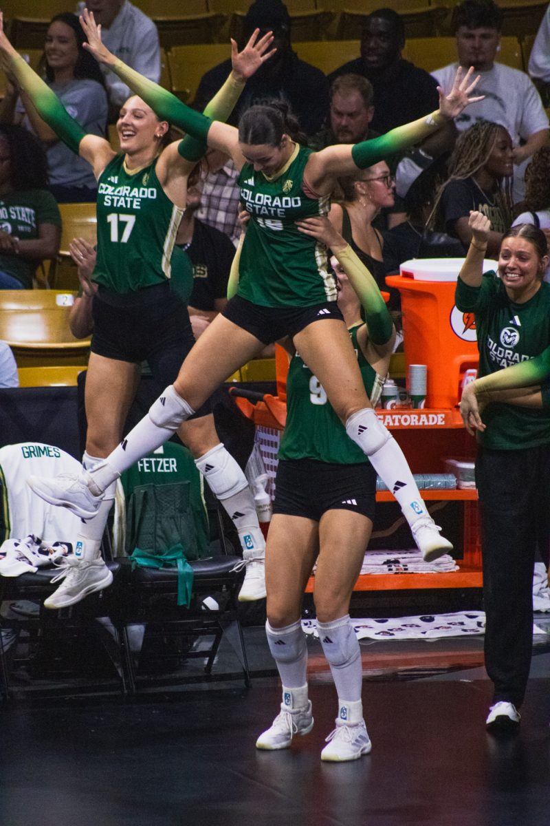 Brenna Rowland (9), a senior on the Colorado State University volleyball team, lifts her teammate Jaedyn Riley (16) to celebrate a point during CSU's match against the University of Colorado, Boulder Sept. 17.