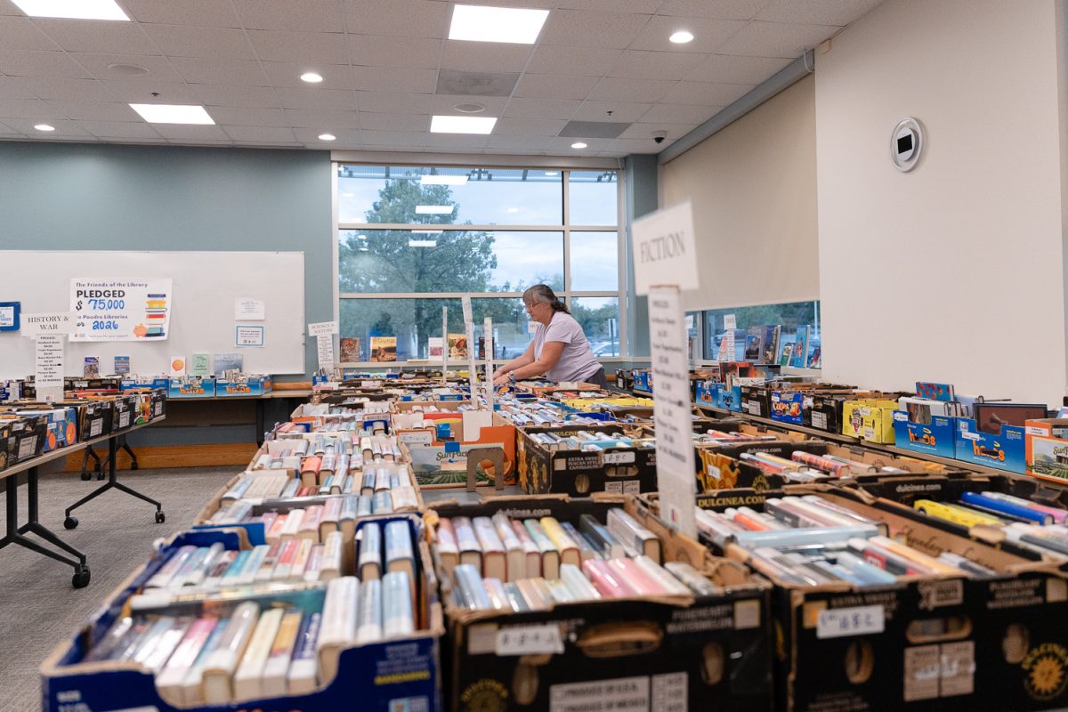 A customer browses through books at Poudre River Friends of the Library's used book sale in Harmony Library Sept. 18.