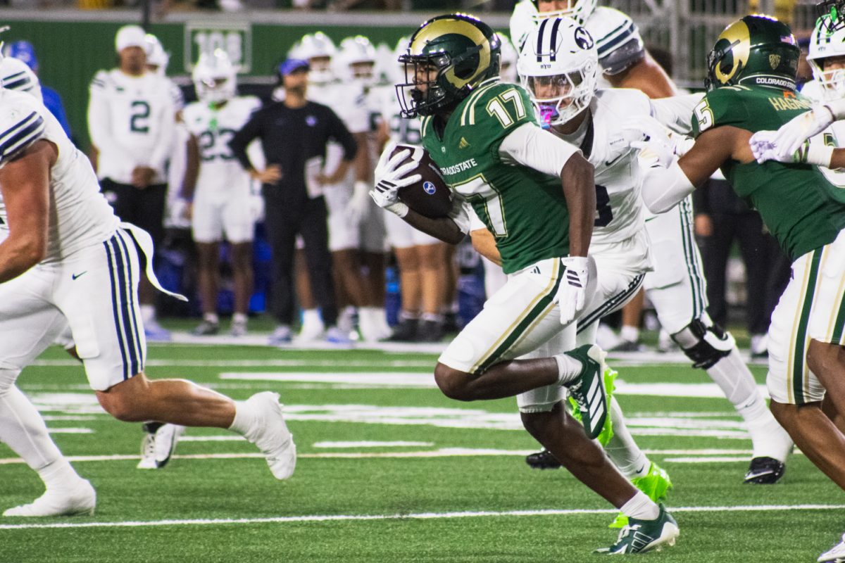 Colorado State University tight end Brock Camp (17) runs the ball down the field under pressure from Brigham Young University defense Sept. 19.  CSU lost the game 41-23.