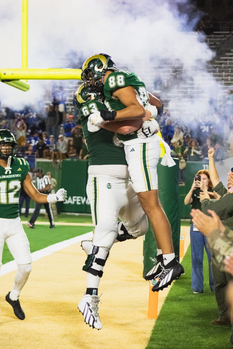 Colorado State University tight end Nader Chirchi (88) celebrates a fourth quarter touchdown with offensive lineman John Holthaus (63) during the Rams' game against the Brigham Young University Cougars Sept. 19. CSU lost the game 41-23.
