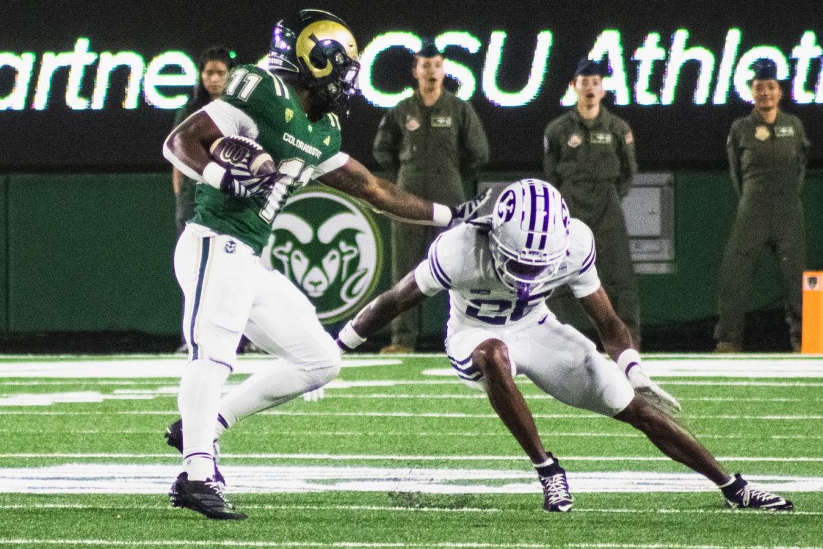 Colorado State University running back Durell Robinson (11) blocks a Brigham Young University player from taking him down Sept. 19. 