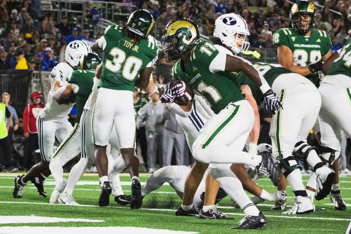 Colorado State University running back Durell Robinson (11) runs the ball past Brigham Young University's defense during CSU's game against BYU in Canvas System Sept. 19.  CSU lost the game 41-23.