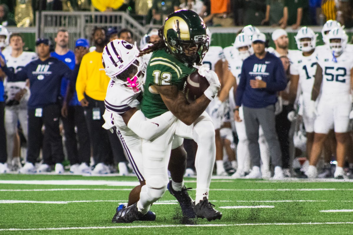 Colorado State University wide receiver Jaivyn Moore pushes for a first down as the Brigham Young University defense tackles him Sept. 19. CSU lost the game 41-23.