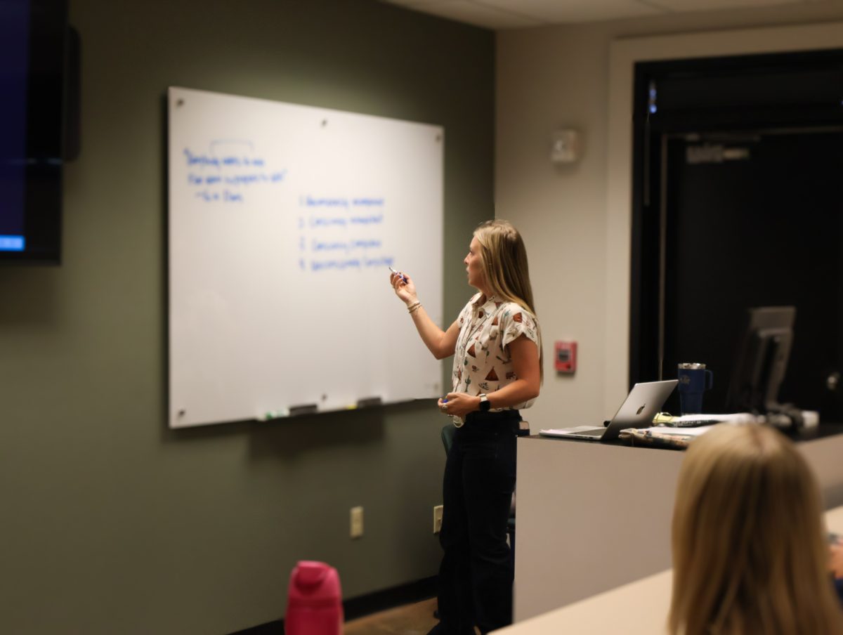 Maggie Murphy, Ph.D., shows horse judging students an idea on the whiteboard of their classroom, Sept. 23.