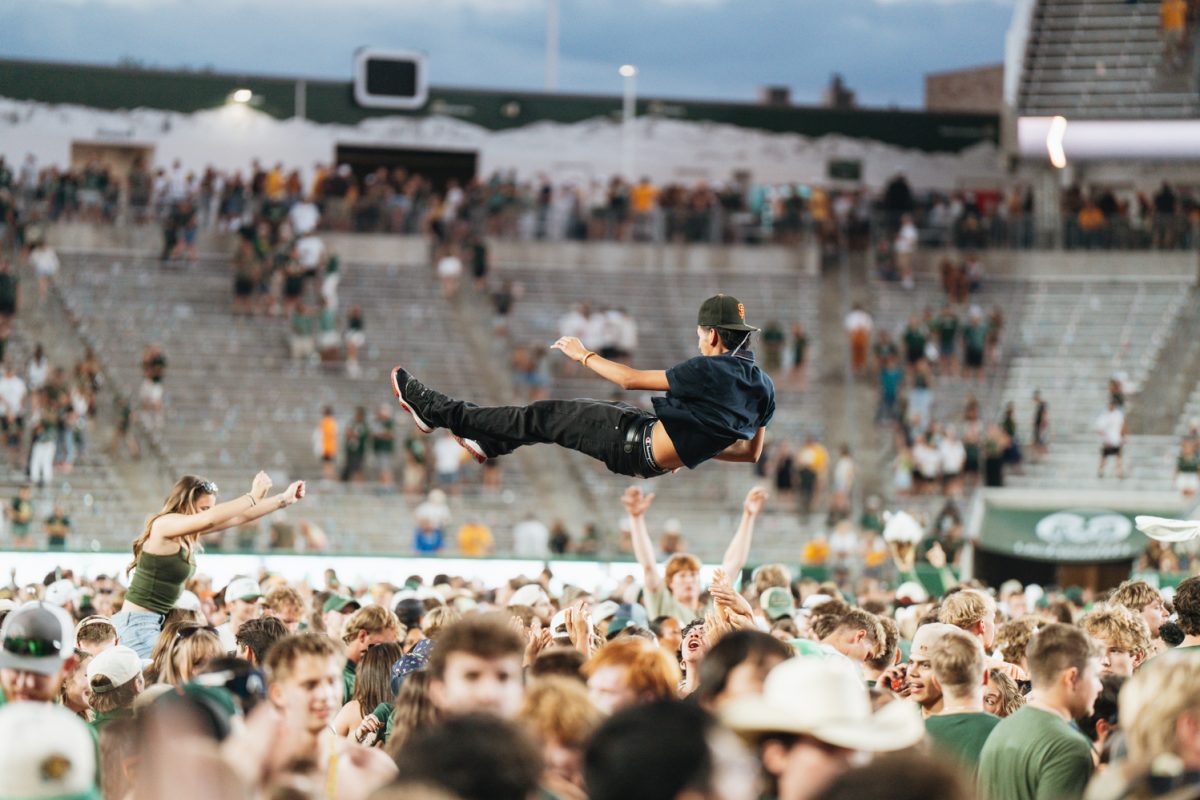 A Colorado State University football fan gets thrown in the air as students rush the field after the final whistle of the Border War game Sept. 5. CSU won against the University of Wyoming 35-13.
