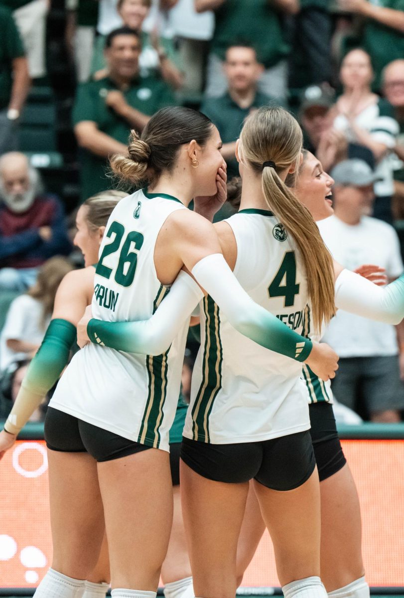 Maria Brun (26) and Halle Jameson (4) hug each other after successfully winning their second set out of three during Colorado State University's game against the University of  South Dakota Sept. 10. Colorado State won 3-0.