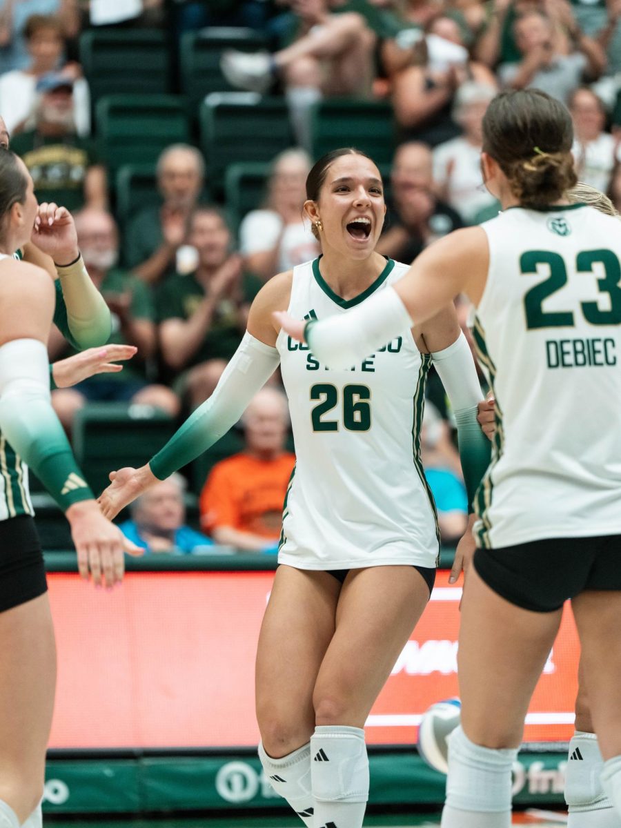 Maria Brun (26) celebrates with her Colorado State University teammates during their match against the University of South Dakota Sept. 10. Colorado State won 3-0.