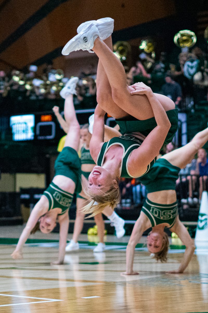A Colorado State University cheerleader does a backflip on the court of Moby arena after the second set of CSU's volleyball game against the Oregon State University Beavers Oct. 10. The Rams lost the first set of the game 26-24 after the lead flipped back and forth between the two teams, but gained momentum in the second set to win the match 3-1.